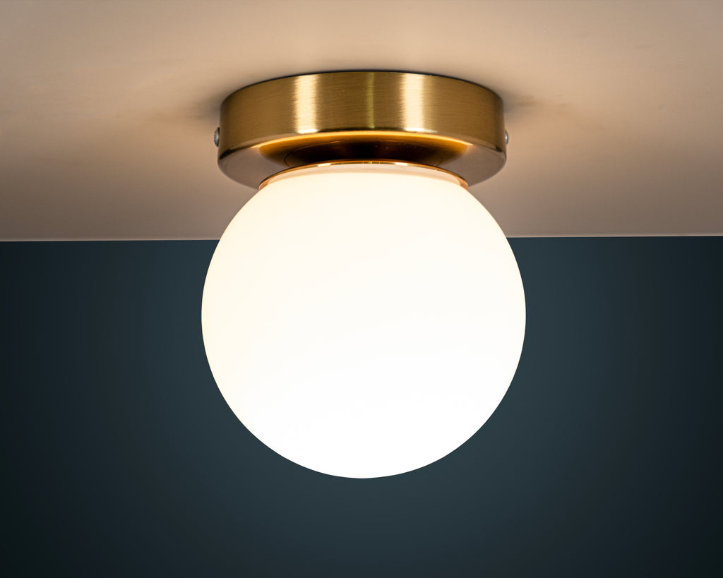 Opal Glass Globe Wall Sconce: Mid-Century Modern Brass Vanity Light